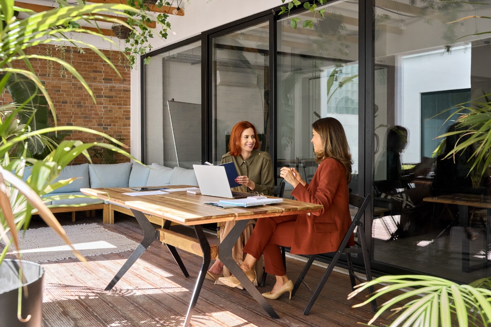 Two women discussing at table