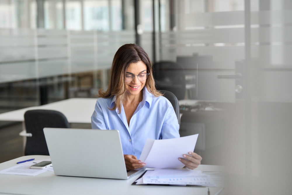 Woman reviewing documents at desk