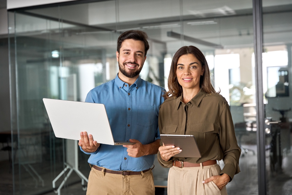 Smiling professionals with devices